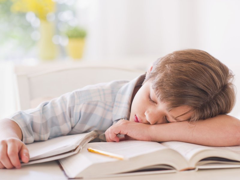 Getty_boy_sleeping_on_books_tired.jpg