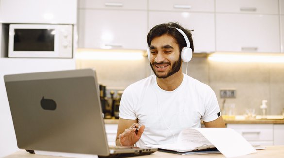 arabic-man-watching-online-webinar-sitting-kitchen-with-computer-enjoying-distance-learning.jpg