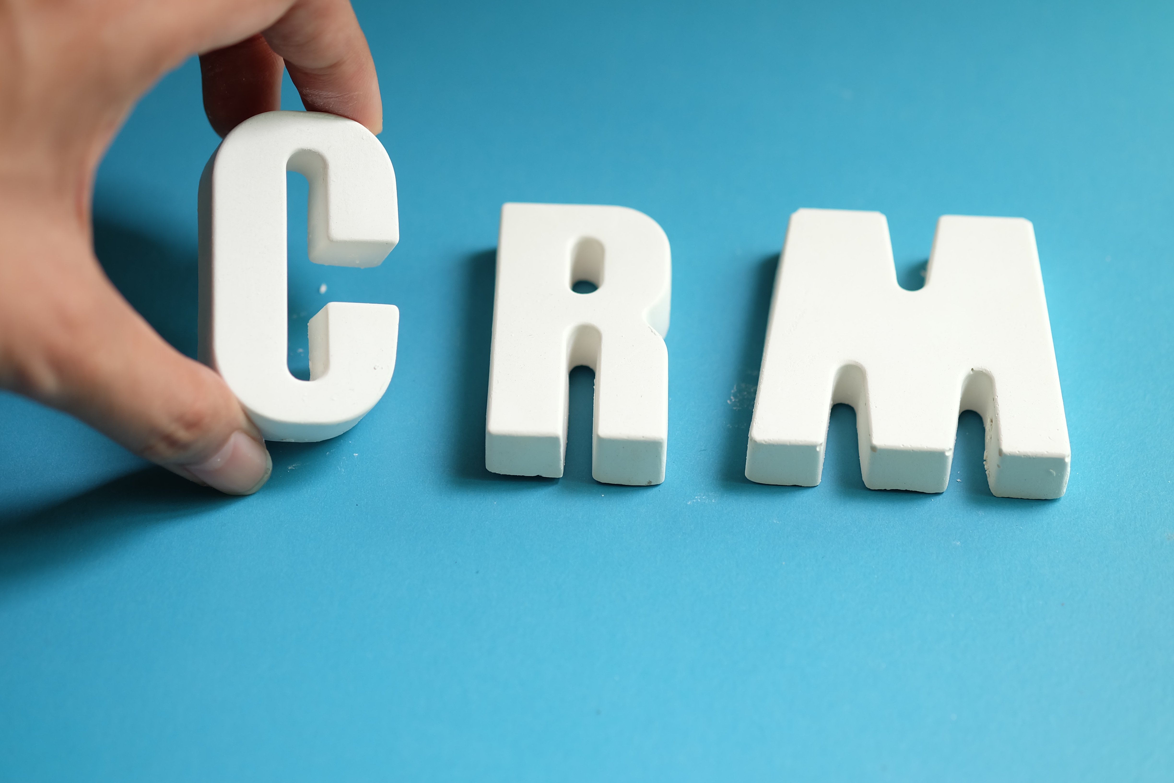 hand-arrange-white-letters-as-crm.jpg